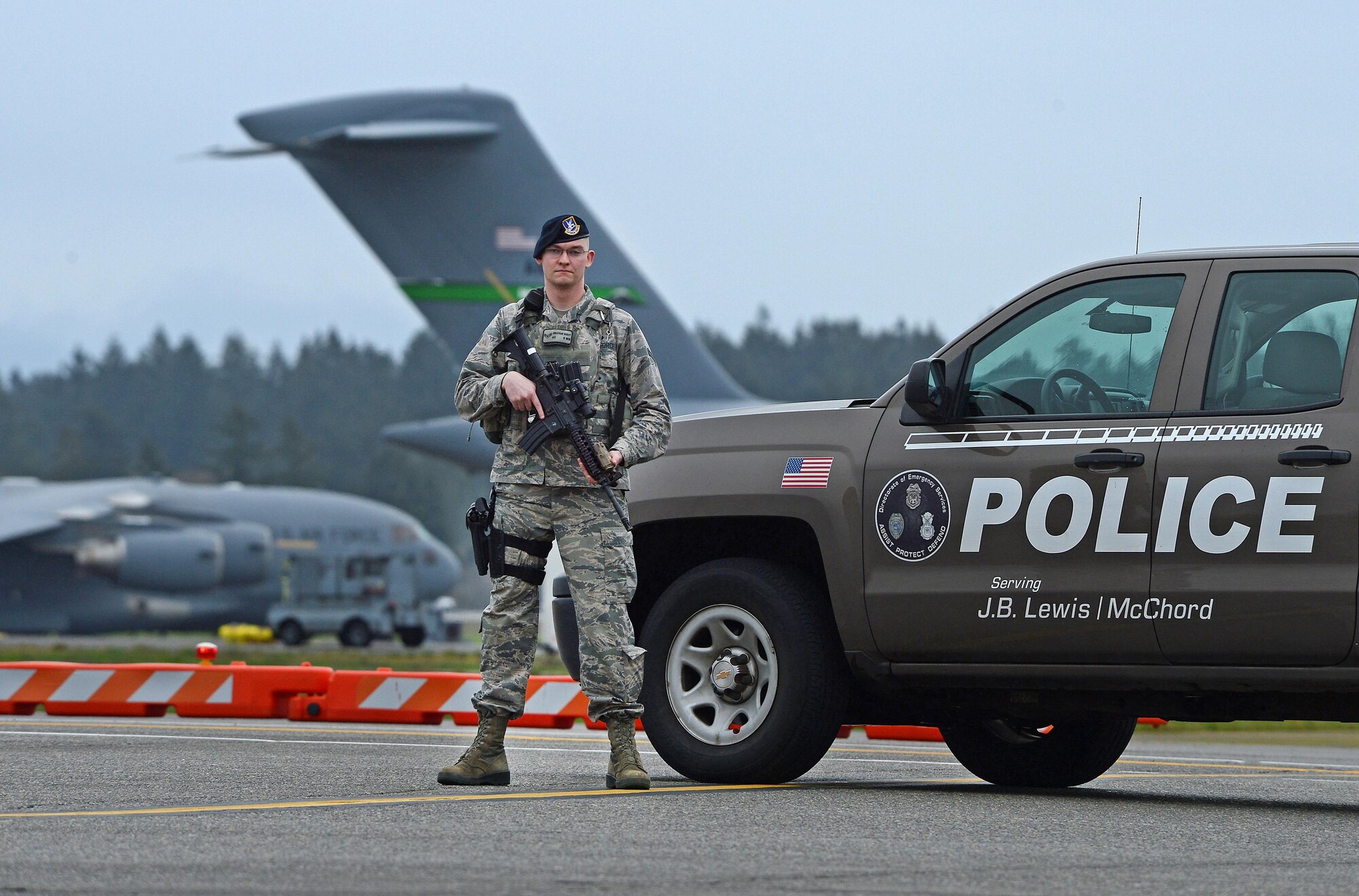 Airman 1st Class Jonathan Hailey, 627th Security Forces Squadron patrolman, stands guard on the McChord Field flightline Mar. 28, 2017 at Joint Base Lewis-McChord, Wash. Armed and trained Airmen from the 627th SFS answer the call of duty every day to ensure the McChord Field flightline is secure at all times by patrolling it with vigilance. (U.S. Air Force photo/Senior Airman Divine Cox)