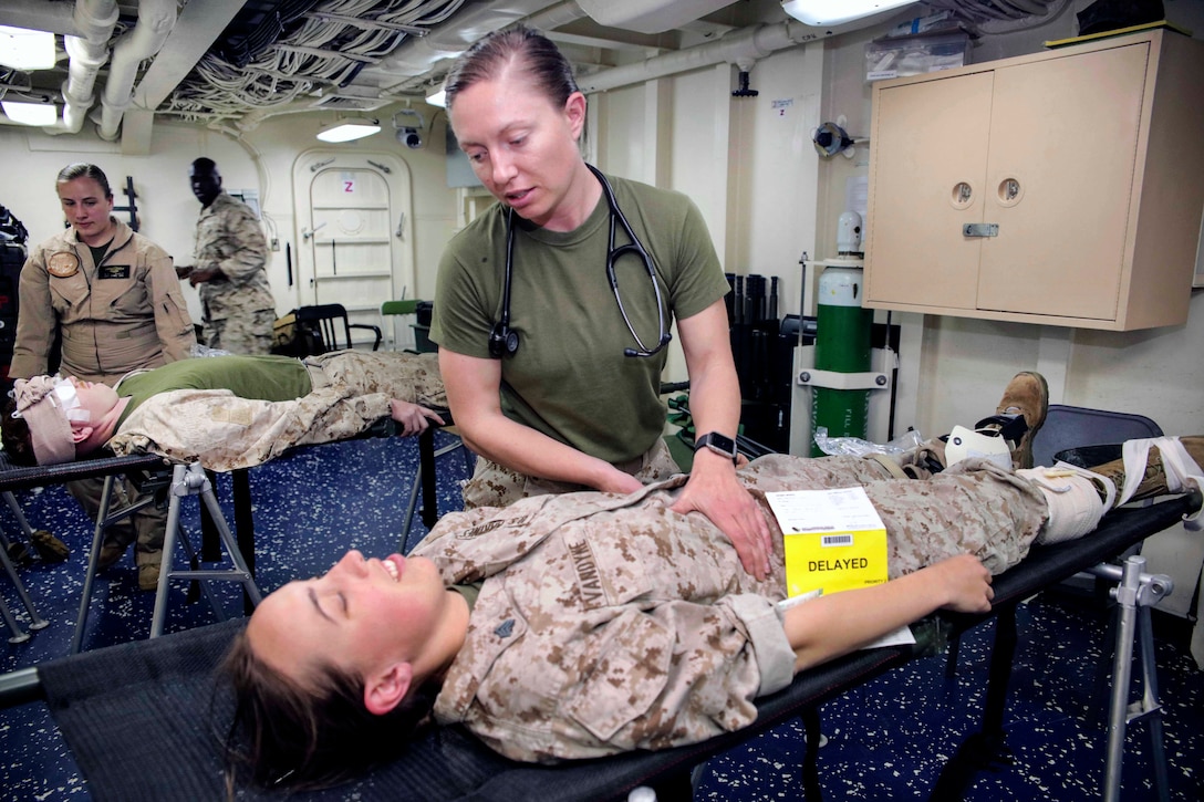 Marine Corps Lt. Rebecca Rausa checks for broken bones on a mock patient during a mass casualty exercise aboard amphibious transport dock ship USS Mesa Verde in the Mediterranean Sea, March 28, 2017. Rausa is a physician assistant assigned to Combat Logistics Battalion 24. Mesa Verde is deployed with the Bataan Amphibious Ready Group to support maritime security operations and theater security cooperation efforts in the U.S. 6th Fleet area of operations. Navy photo by Petty Officer 2nd Class Brent Pyfrom