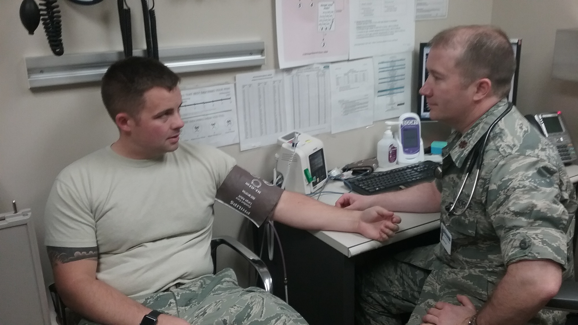 Maj. Matthew Hill, a certified emergency nurse, works in the Emergent Care Center at Malcolm Grow Medical Clinics and Surgery Center, on Joint Base Andrews, Md., and discusses treatment with a patient, Tech. Sgt. Scottie Eubank. (U.S. Air Force photo by Staff Sgt. Hadley Owen)