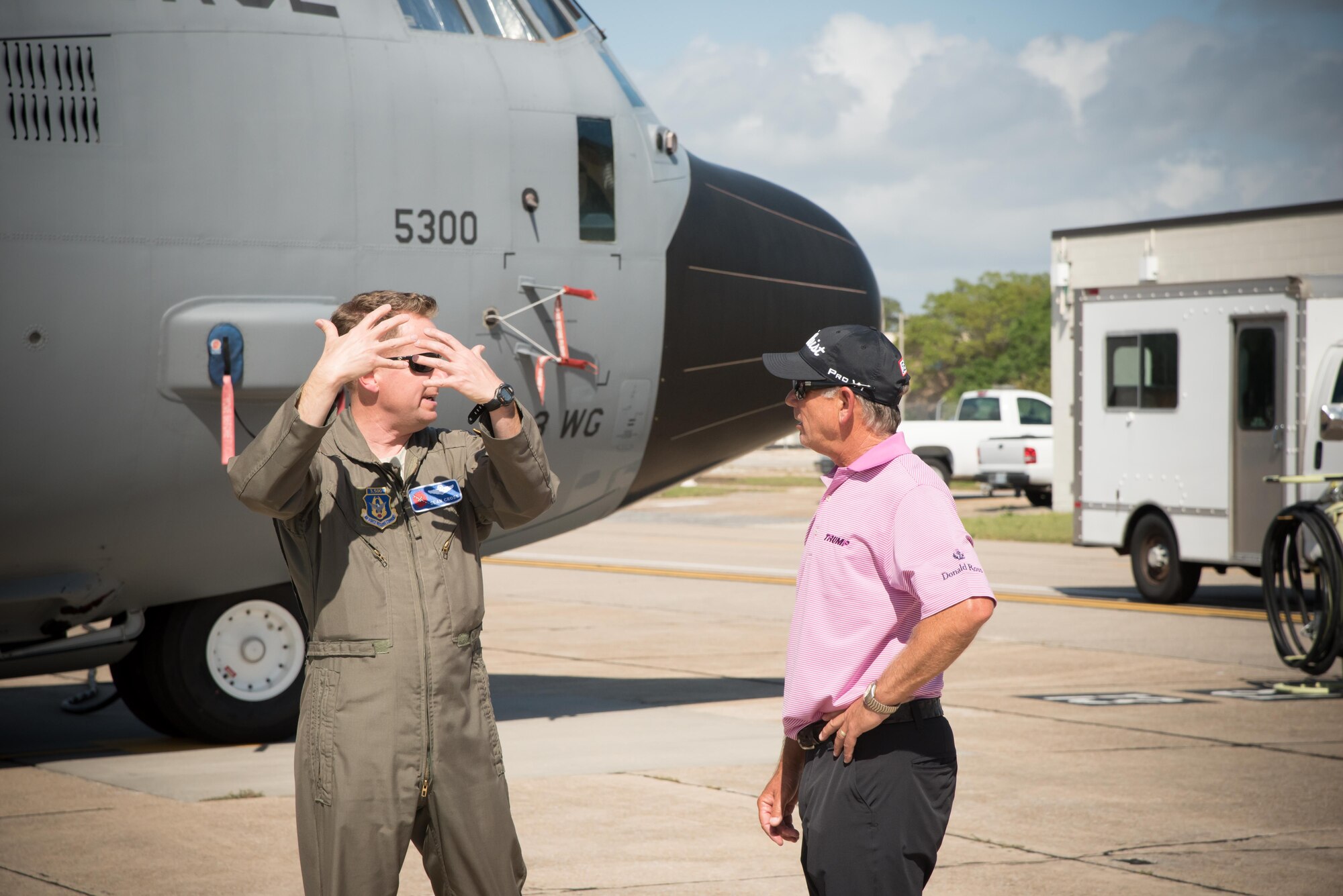 Lt. Col. Sean Cross, 53rd Weather Reconnaissance Squadron pilot, explains his squadron's mission and capabilities to Professional Golfers' Association golfer Mike Goodes March 29 at Keesler Air Force Base, Mississippi. (U.S. Air Force photo/Maj. Marnee A.C. Losurdo)