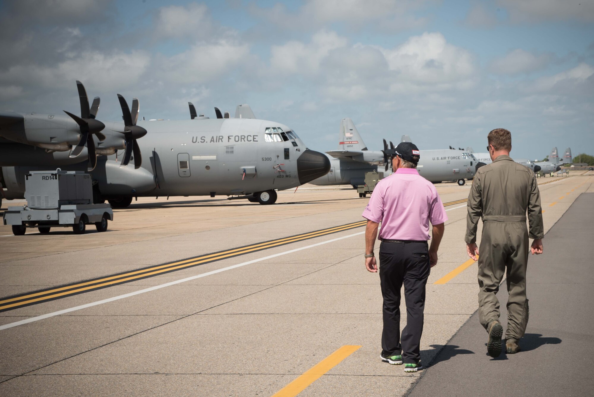 Lt. Col. Sean Cross, 53rd Weather Reconnaissance Squadron pilot, explains his squadron's mission and capabilities to Professional Golfers' Association golfer Mike Goodes March 29 at Keesler Air Force Base, Mississippi. (U.S. Air Force photo/Maj. Marnee A.C. Losurdo)