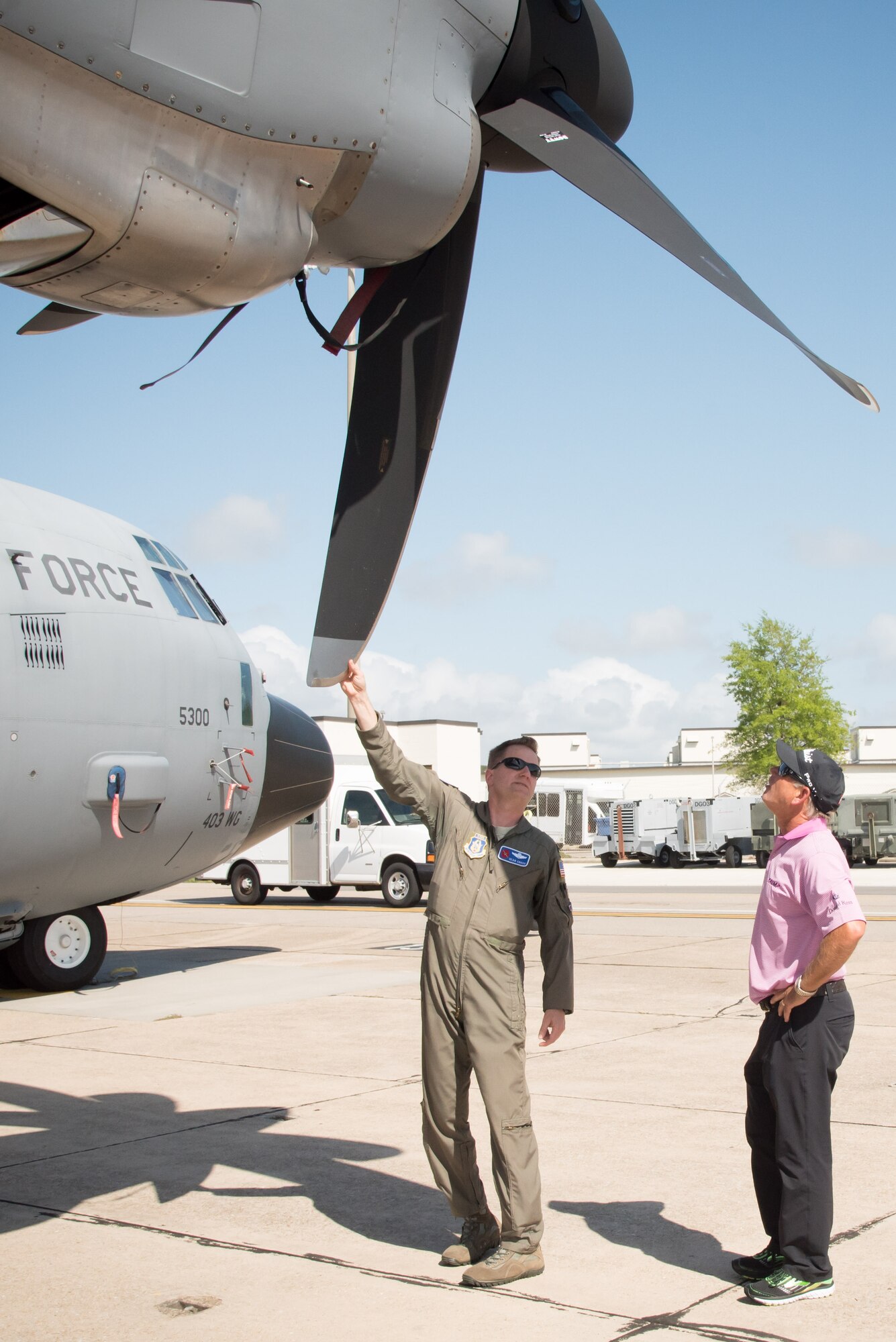 Lt. Col. Sean Cross, 53rd Weather Reconnaissance Squadron pilot, explains his squadron's mission and capabilities to Professional Golfers' Association golfer Mike Goodes March 29 at Keesler Air Force Base, Mississippi. (U.S. Air Force photo/Maj. Marnee A.C. Losurdo)