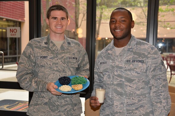 Capt. Jeffery Perry and Senior Airman Bryan Metcalfe from the 60th Diagnostics and Therapeutics Squadron hold the My Plate model during the 60th Inpatient Squadron training day on March 21 at David Grant USAF Medical Center, Travis Air Force Base Calif.  Perry and Metcalfe sampled food from each flight, and selected the plate that was closest to the My Plate recommendation as the winner.  Their goal plate was focused on variety, amount and nutrition, as well as foods and beverages low in saturated fat, sodium and added sugars.