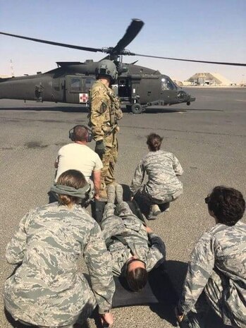 Capt. (Dr.) Betsy Reese, right front, simulates loading a patient for air evacuation during training at a deployed location. Reese recently returned from a deployment in Southeast Asia and serves as a family medicine doctor at Hill Air Force Base, Utah. (Courtesy photo)