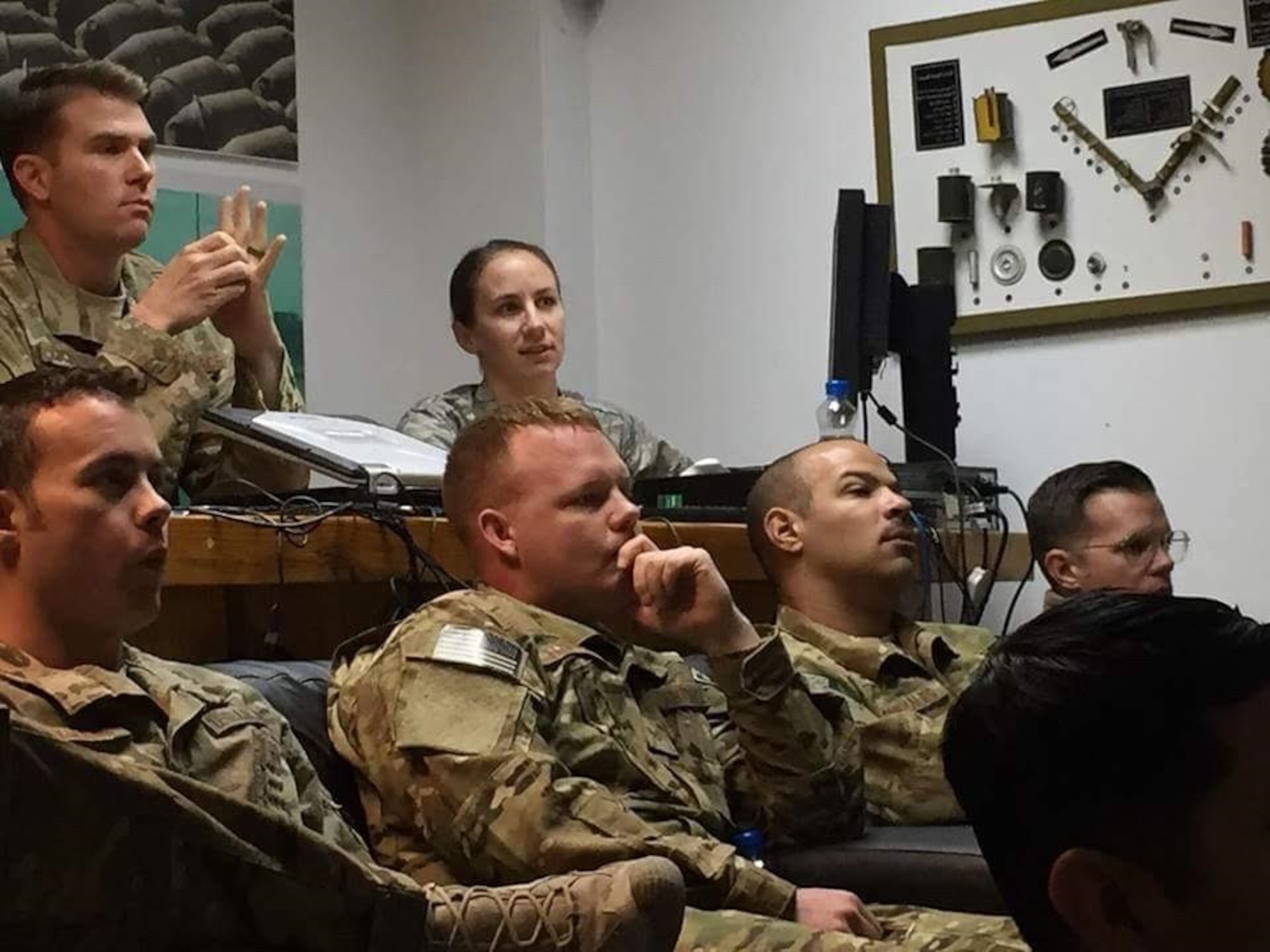 Capt. (Dr.) Betsy Reese, rear right, and Explosive Ordnance Disposal (EOD) team members review supplement safety and sports nutrition slides at a deployed location in November 2016. Reese recently returned from a deployment in Southeast Asia and serves as a family medicine doctor at Hill Air Force Base, Utah. (Courtesy photo)