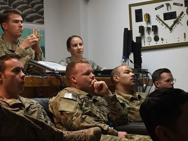 Capt. (Dr.) Betsy Reese, rear right, and Explosive Ordnance Disposal (EOD) team members review supplement safety and sports nutrition slides at a deployed location in November 2016. Reese recently returned from a deployment in Southeast Asia and serves as a family medicine doctor at Hill Air Force Base, Utah. (Courtesy photo)