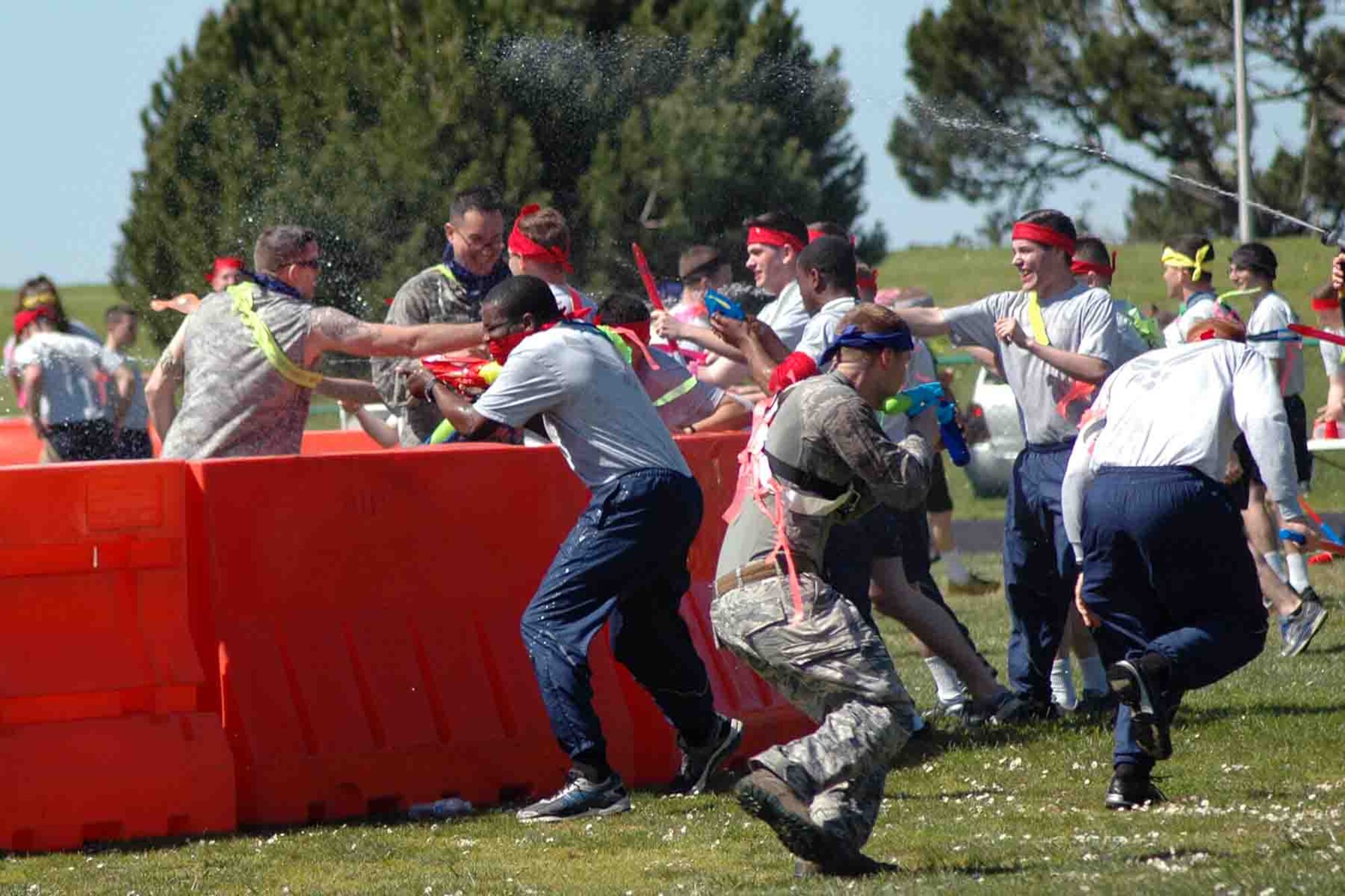 Airmen from the 311th Training Squadron storm the 311th Headquarters staff who protect their flag behind barricades at the Hilltop Track March 11 during the unit's combat dining-in. (Photo Credit: Mr. Brian Lepley (Presidio))