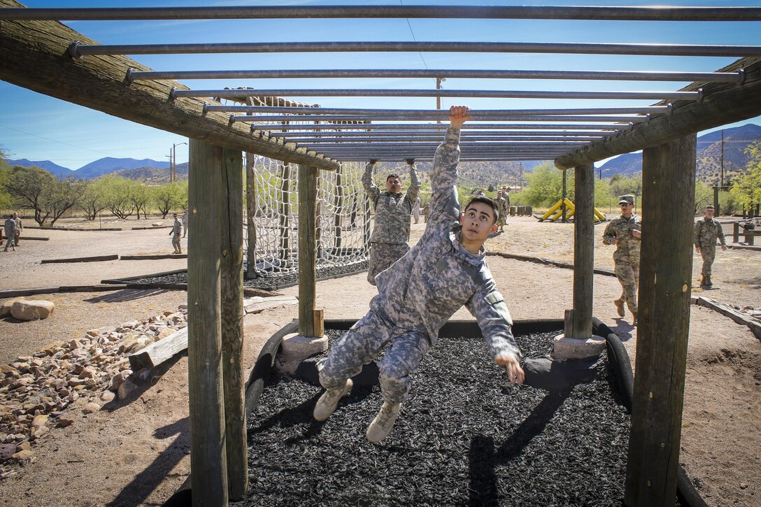 Army Spc. Julian Ditona swings across an obstacle at Fort Huachuca, Ariz., March 28, 2017. Ditona, a multichannel transmission systems operator/maintainer, is a reservist assigned to the 98th Expeditionary Signal Battalion, 335th Signal Command. He and seven other soldiers are competing in the command’s 2017 Best Warrior Competition, hoping to represent their unit at the main event later this year. Army Reserve photo by Sgt. 1st Class Brent C. Powell