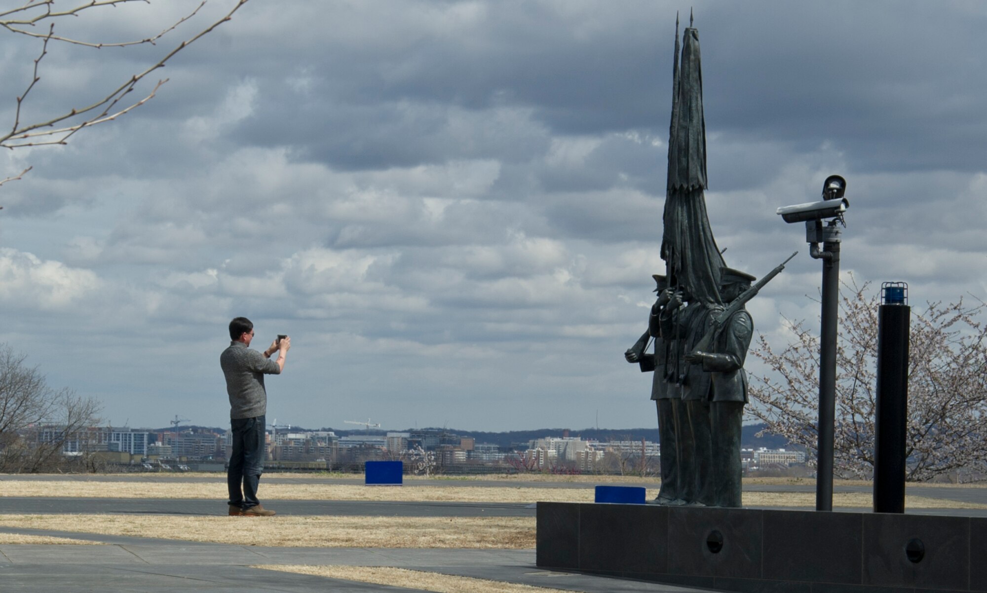 A visitor to the U.S. Air Force Memorial photographs statues that portray Airmen from The U.S. Air Force Honor Guard March 28, 2017 in Arlington, Virginia. The Air Force Memorial, located at 1 Air Force Memorial Way, is free and open to the public. (U.S. Air Force photo by Staff Sgt. Joe Yanik)