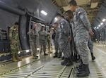 Senior Master Sgt. A. Clark, a 356th Airlift Squadron flight engineer, shows students from the  Inter-American Air Forces Academy how the rollers on the C-5M Super Galaxy aircraft are used to load cargo March 29, 2017 at Joint Base San Antonio-Lackland, Texas. As part of their tour the students also toured the structural, metals,  survival, and engine shops.  (U.S. Air Force photo by Benjamin Faske)