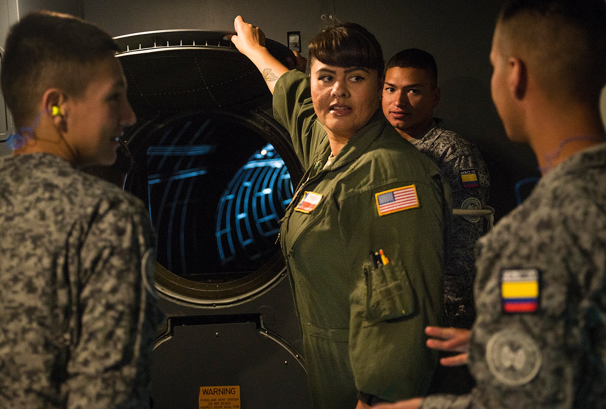 Staff Sgt. Crystal McKerracher, a 68th Airlift Squadron flight engineer, shows students from the Inter-American Air Forces Academy the tail compartment of the C-5M Super Galaxy aircraft March 29, 2017 at Joint Base San Antonio-Lackland, Texas. As part of their tour the students also toured the structural, metals,  survival, and engine shops.  (U.S. Air Force photo by Benjamin Faske)