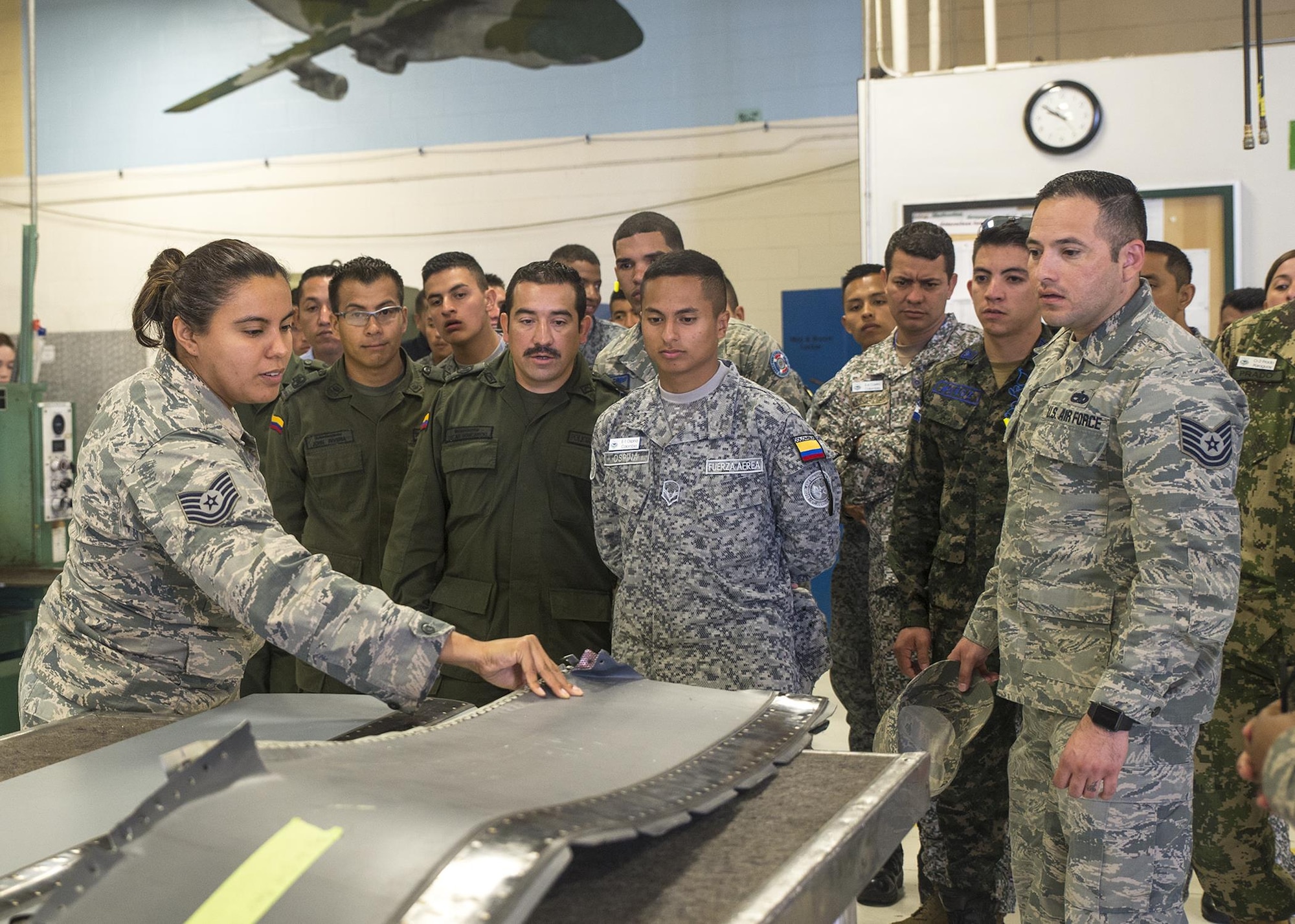 Tech. Sgt. Stephanie Rymers, a 433rd Maintenance Squadron sheet metal mechanic, shows students from the Inter-American Air Forces Academy a damaged piece metal from a C-5M Super Galaxy aircraft  March 29, 2017 at Joint Base San Antonio-Lackland, Texas. As part of their tour the students toured a C-5M Super Galaxy aircraft and visited the structural, metals, and survival shops. (U.S. Air Force photo by Benjamin Faske)