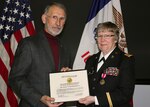 Iowa Army National Guard Chief Warrant Officer 3 Cathy Hill, of Winterset, Iowa, receives her Roll of Retired Officer Personnel certificate from retired Col. Robert King during her retirement ceremony March 4, 2017, at Joint Forces Headquarters in Johnston, Iowa. Hill, a former property accounting technician, was one of just three remaining Soldiers in the Iowa National Guard who originally joined the Women’s Army Corps, a separate branch of service for women created during World War II and disbanded in 1978. 