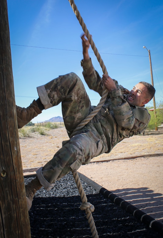 Army Reserve Sgt. Anderson Rodriguez, a satellite communications operator/maintainer, assigned to the Joint Communications Squadron, 4th Joint Communications Support Element, 335th Signal Command (Theater), pulls himself up a wooden wall at the obstacle course during the command's 2017 Best Warrior Competition at Fort Huachuca, Arizona, March 29.  Eight Soldiers are competing in the five-day competition to see who will go on to represent the command in the U.S. Army Reserve Command's Best Warrior Competition later this year.  (Official U.S. Army photo by Sgt. 1st Class Brent C. Powell)