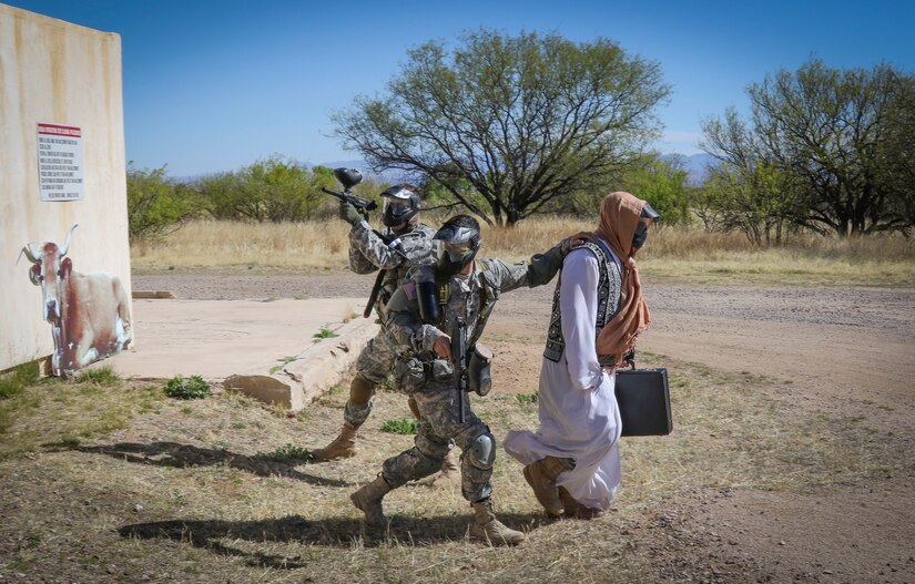 Two Army Reserve Soldiers from the 335th Signal Command (Theater), escort a VIP role player from a village to complete an urban operations event during the command's 2017 Best Warrior Competition at Fort Huachuca, Arizona March 29.  Eight Soldiers from across the country have been competing in the competition for three days vying to see who will be the best candidate to represent the command later this year at the U.S. Army Reserve Command's Best Warrior Competition.  (U.S. Army Reserve photo by Sgt. 1st Class Brent C. Powell)
