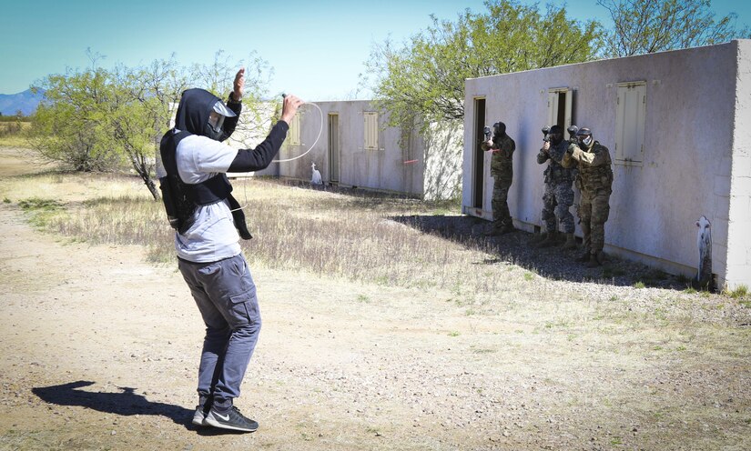 A team of U.S. Army Reserve Soldiers from the 335th Signal Command (Theater) fire paintballs at a role player wearing a suicide vest during an urban operations scenario in the command's 2017 Best Warrior Competition at Fort Huachuca, Arizona, March 29.  The five-day competition challenges the Soldiers in a variety of physical and mental events to see who will represent the command in the U.S. Army Reserve Command's Best Warrior Competition later this year.  (U.S. Army Reserve photo by Sgt. 1st Class Brent C. Powell)