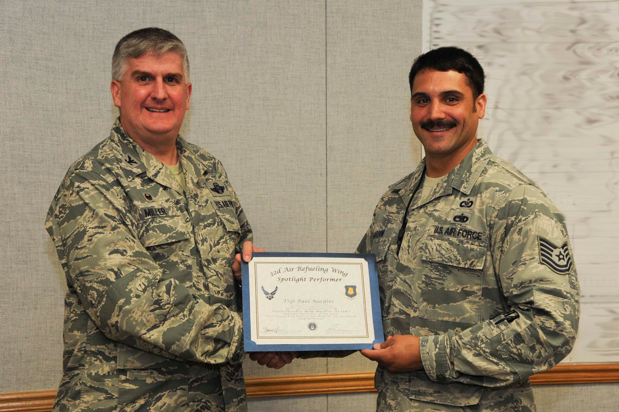 Tech. Sgt. Paul Nardini, 22nd Air Refueling Wing command and control procedures instructor,  poses with Col. Albert Miller, 22nd Air Refueling Wing commander, March 28, 2017, at McConnell Air Force Base, Kan. Nardini received the spotlight performer for the week of March 13–17. This photo has been edited for security purposes. (U.S. Air Force photo/Airman 1st Class Jenna K. Caldwell) 