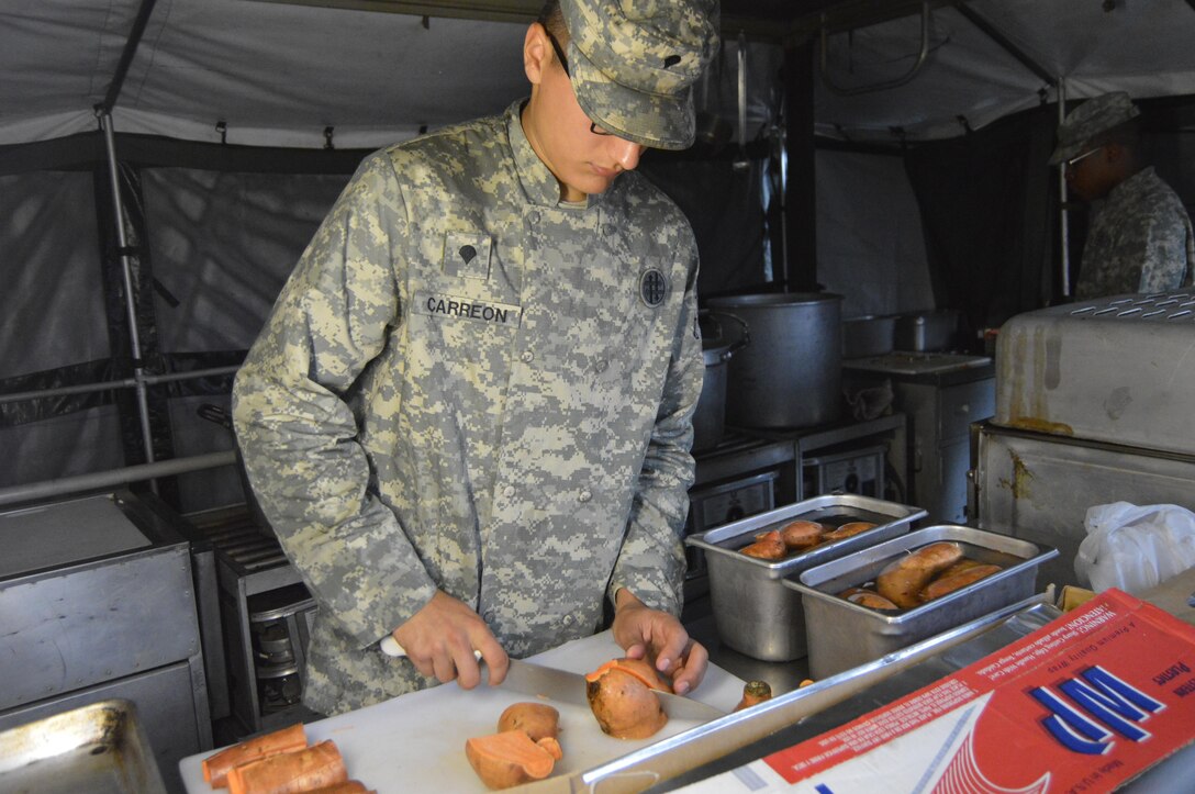 U.S. Army Reserve Spc. Adrian Carreon, a culinary specialist assigned to the 1002nd Quartermaster Company in Beaumont, Texas, slices sweet potatoes during the Philip A. Connelly cooking competition held at Fort Polk, Louisiana, March 25, 2017. During the Philip A. Connelly Program, the U.S. Army Reserve partners with the National Restaurant Association to give food service personnel an opportunity to demonstrate their capability and combat-readiness while competing for recognition. (U.S. Army Reserve photo by Master Sgt. Dave Thompson)