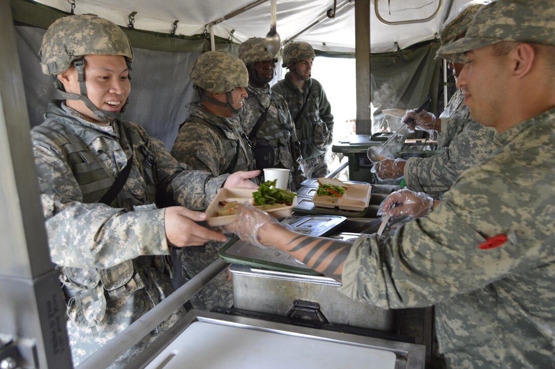 Soldiers with the U.S. Army Reserve’s 1002nd Quartermaster Company from Beaumont, Texas, are being served a hot meal by their food service team during their Field Training Exercise March 25, 2017. The 1002nd is a subordinate unit of the 4th Sustainment Command (Expeditionary) and part of America’s Army Reserve. These units are trained, combat-ready and equipped to provide military and logistical support in any corner of the globe. (U.S. Army Reserve photo by Master Sgt. Dave Thompson)