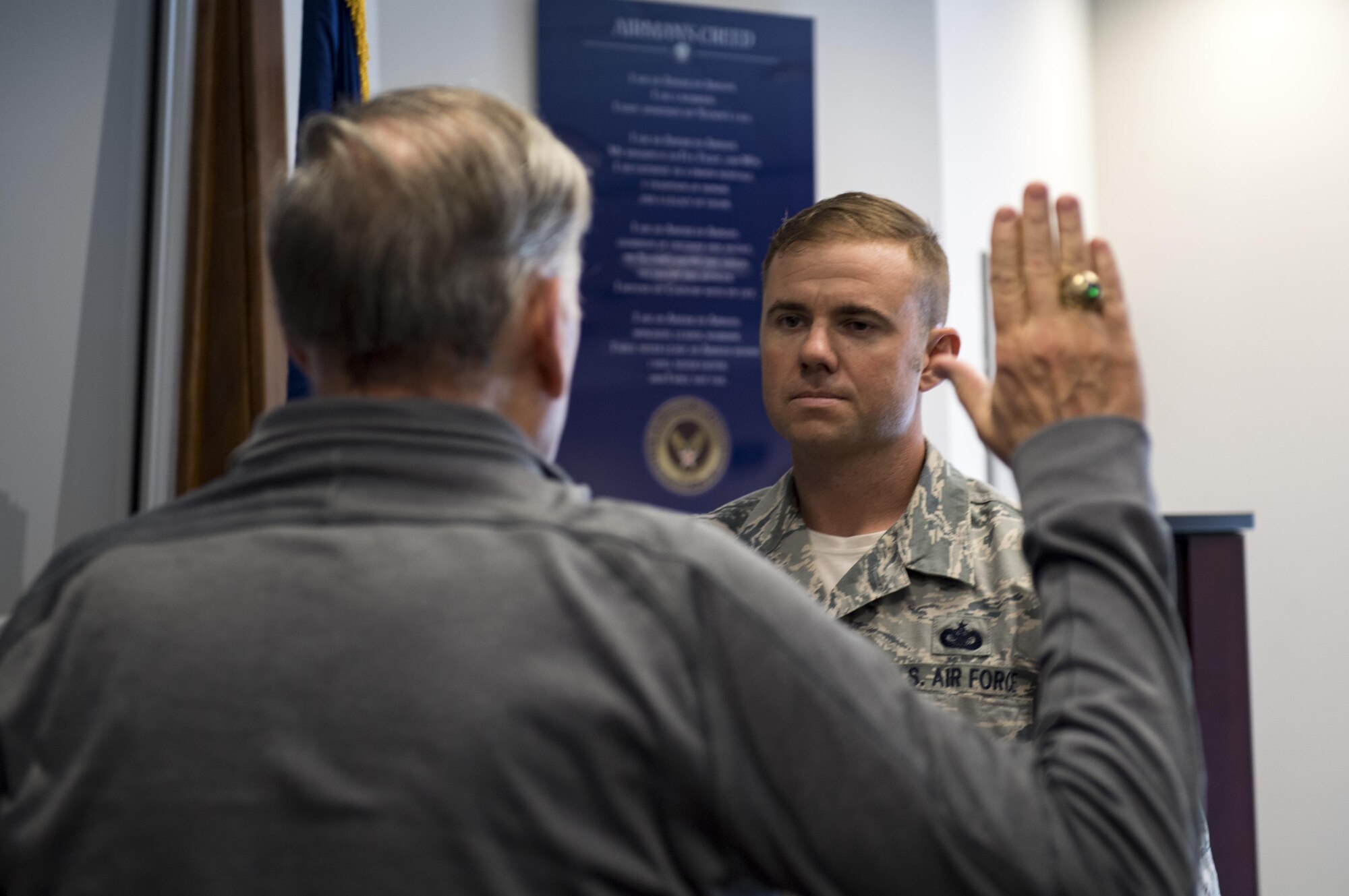 Retired chief of staff Gen. John Jumper reenlists Staff Sgt. Scott Shirley, 824th Base Defense Squadron NCO in charge of plans and programs, during the 820th Base Defense Group’s 20th Anniversary Ceremony, March 28, 2017, at Moody Air Force Base, Ga. Jumper was a command pilot with more than 5,000 flying hours, including 1,400 combat hours. The celebration included an 820th BDG capabilities demo, a reenlistment ceremony and a formal dinner. (U.S. Air Force photo by Airman 1st Class Daniel Snider)