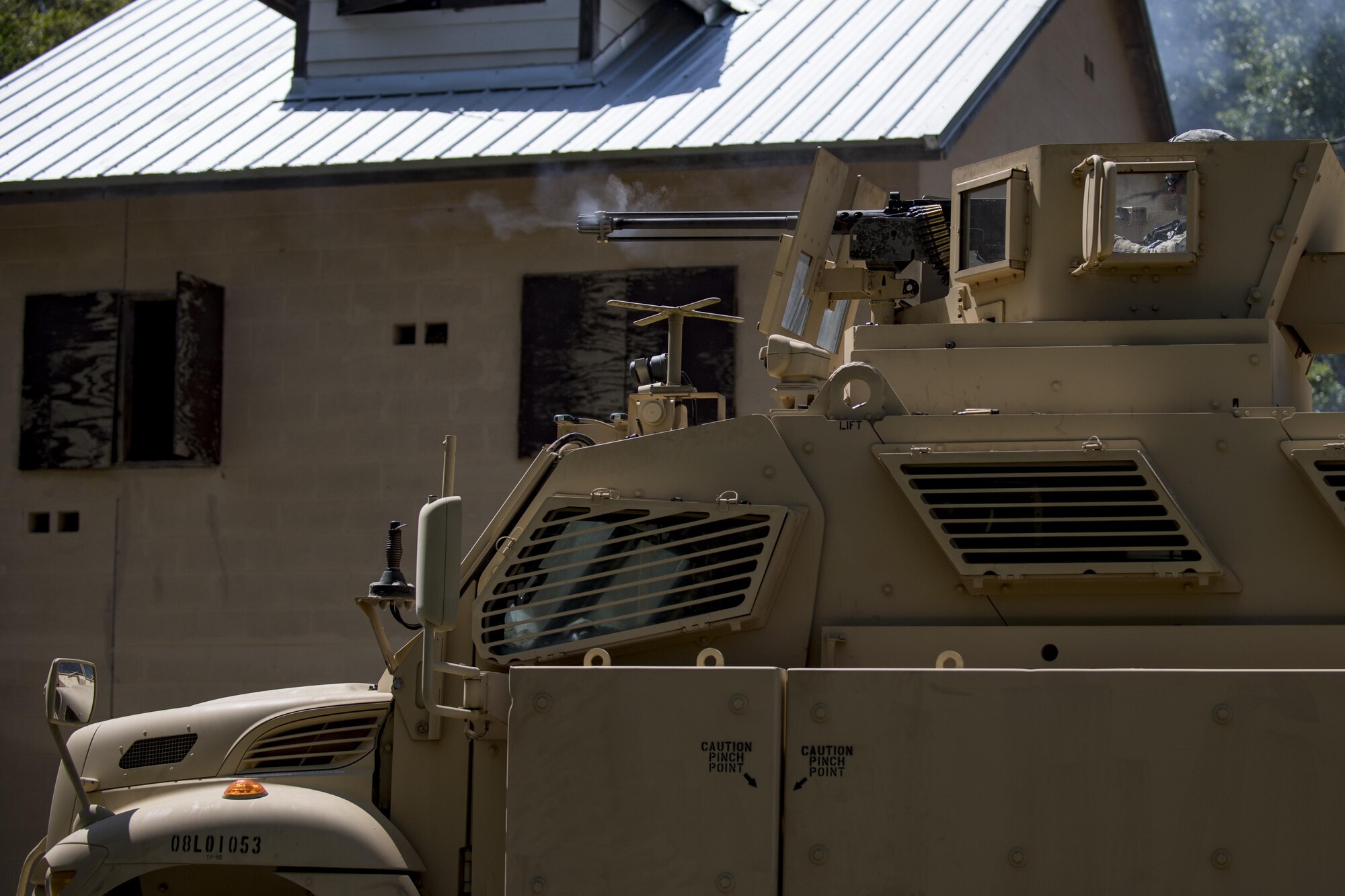 A member of the 822d Base Defense Squadron fires off the M2 Browning .50 caliber machine gun attached to the top of a mine-resistant, ambush-protected vehicle during the 820th Base Defense Group’s 20th Anniversary Ceremony, March 28, 2017, at Moody Air Force Base, Ga. Retired chief of staff Gen. John Jumper and his wife, Ellen, and many former members of the 820th BDG visited to celebrate the anniversary. (U.S. Air Force photo by Airman 1st Class Daniel Snider)