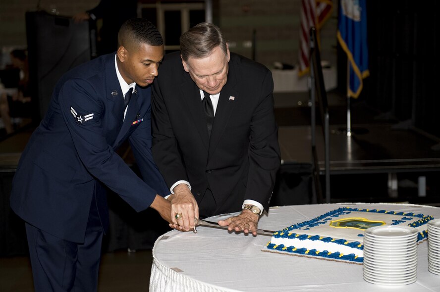 Airman 1st Class Christopher Smith, 823rd Base Defense Squadron fire team member, and Retired chief of staff Gen. John Jumper, perform a cake cutting ceremony, during the 820th Base Defense Group’s 20th Anniversary Celebration, March 29, 2017, in Valdosta, Ga. Jumper was a command pilot with more than 5,000 flying hours, including 1,400 combat hours. The celebration included an 820th BDG capabilities demo, a reenlistment ceremony and a formal dinner. (U.S. Air Force photo by Airman 1st Class Daniel Snider)