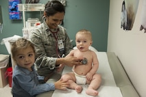 Capt. Manisha Mills, a 49th MDOS pediatrician, checks her patient's heart rate March 29, 2017 at Holloman Air Force Base, N.M. Mills' framework consists of about 20-23 appointments per day and in between those appointments, she takes walk-in clients. (U.S. Air Force photo by Airman 1st Class Ilyana A. Escalona)