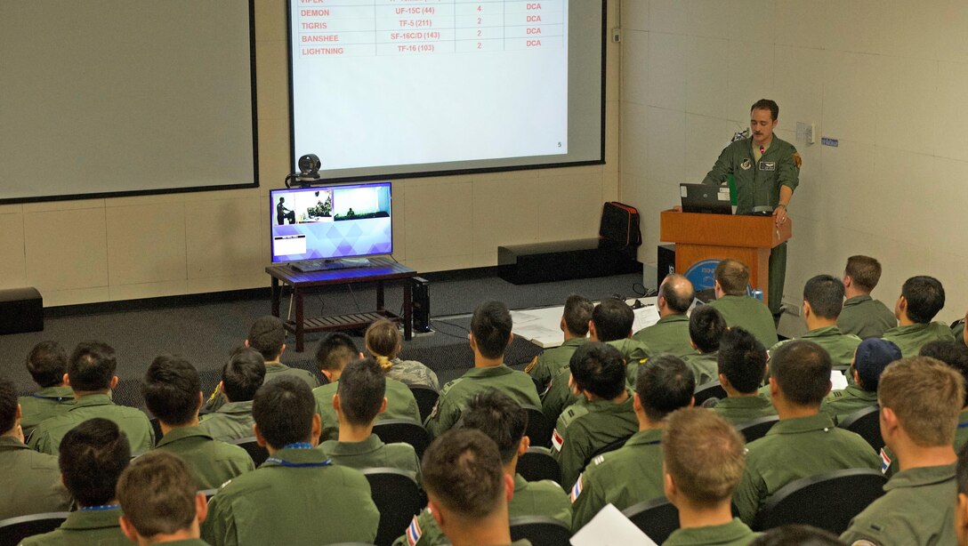 Over 100 members of the Royal Thai air force (RTAF), Republic of Singapore air force (RSAF) and U.S. Air Force (USAF) participate in a mass briefing for a large force employment (LFE) exercise during Cope Tiger 17 at Korat Royal Thai Air Force Base, Thailand, March 29, 2017. On average, over 50 aircraft from the three nations work together in the air, under simulated combat stressors at the same time during LFEs. The annual multilateral exercise, which involves a combined total of 76 aircraft and 43 air defense assets, is aimed at improving combined combat readiness and interoperability between the RSAF, RTAF, and USAF, while concurrently enhancing the three nations' military relations. (U.S. Air Force photo by Staff Sgt. Kamaile Chan)