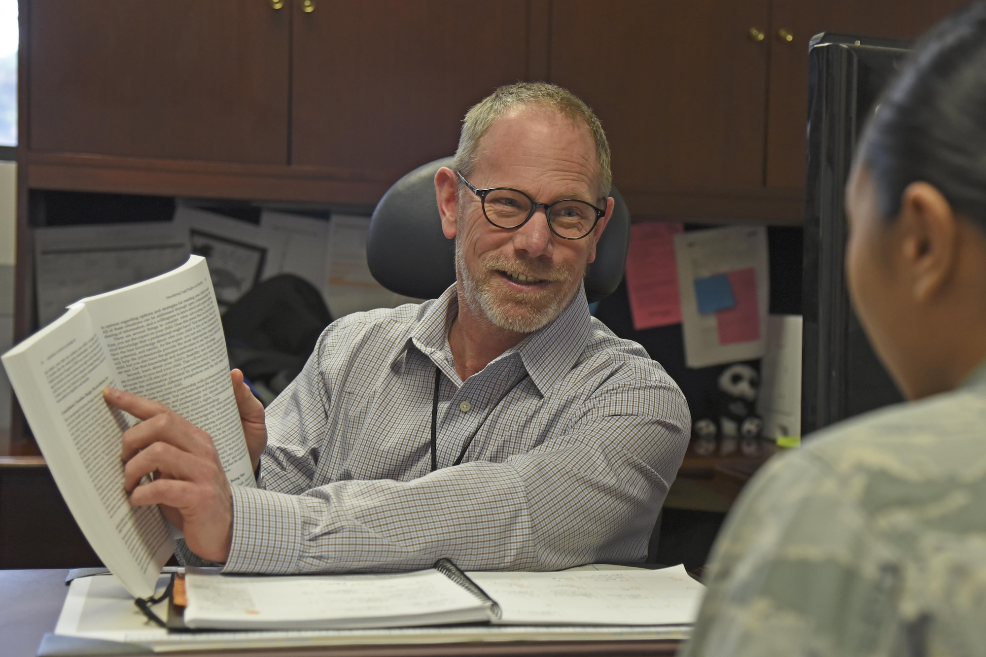 Steve McMullen speaks with an Airman regarding the Exceptional Family Member Program, its importance and how it benefits military families around the world, Mar. 27, 2017, at Fairchild Air Force Base, Washington. McMullen is the Airman and Family Readiness Center school liaison officer and the EFMP family support coordinator at Fairchild. He provides coordination of family support services to EFMs who have physical, developmental, emotional or an intellectual impairment. (U.S. Air Force photo/Senior Airman Mackenzie Richardson)