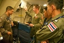 U.S. Air Force Capt. Dan Eyrolles (center) with the 961st Airborne Air Control Squadron from Kadena Air Base, Japan, briefs three Royal Thai air force members prior to their mission aboard a U.S. Air Force E-3 Sentry Airborne Warning and Control System (AWACS) during exercise Cope Tiger 17 at Korat Royal Thai Air Force Base, Thailand, March 28, 2017. The E-3 provides airborne command and control, long-range surveillance, detection and identification information, further maximizing interoperability between the U.S., Thai and Singapore militaries which is essential in tackling non-traditional security challenges such as maritime security and terrorism. (U.S. Air Force photo by Staff Sgt. Kamaile Chan)
