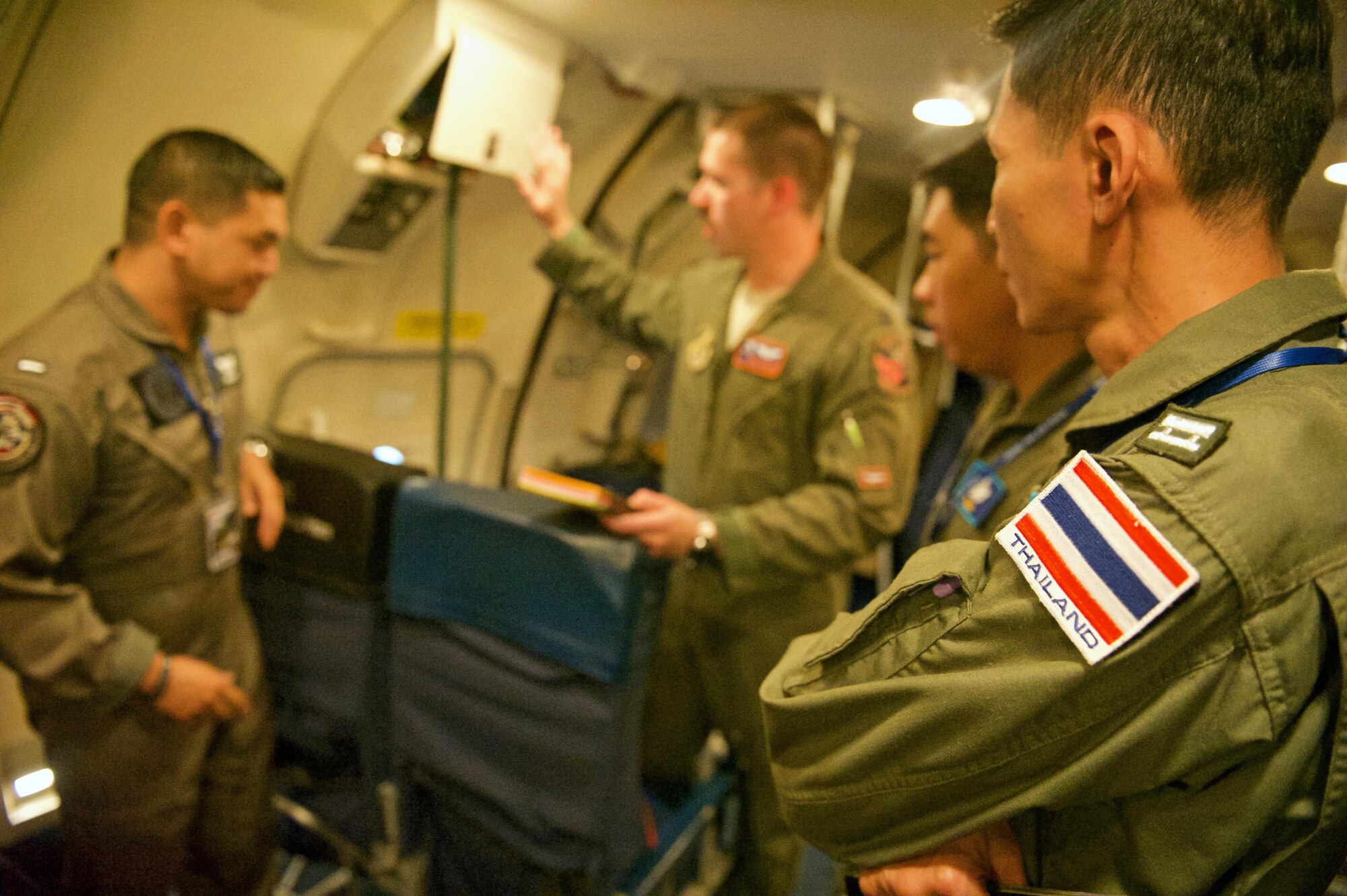 U.S. Air Force Capt. Dan Eyrolles (center) with the 961st Airborne Air Control Squadron from Kadena Air Base, Japan, briefs three Royal Thai air force members prior to their mission aboard a U.S. Air Force E-3 Sentry Airborne Warning and Control System (AWACS) during exercise Cope Tiger 17 at Korat Royal Thai Air Force Base, Thailand, March 28, 2017. The E-3 provides airborne command and control, long-range surveillance, detection and identification information, further maximizing interoperability between the U.S., Thai and Singapore militaries which is essential in tackling non-traditional security challenges such as maritime security and terrorism. (U.S. Air Force photo by Staff Sgt. Kamaile Chan)