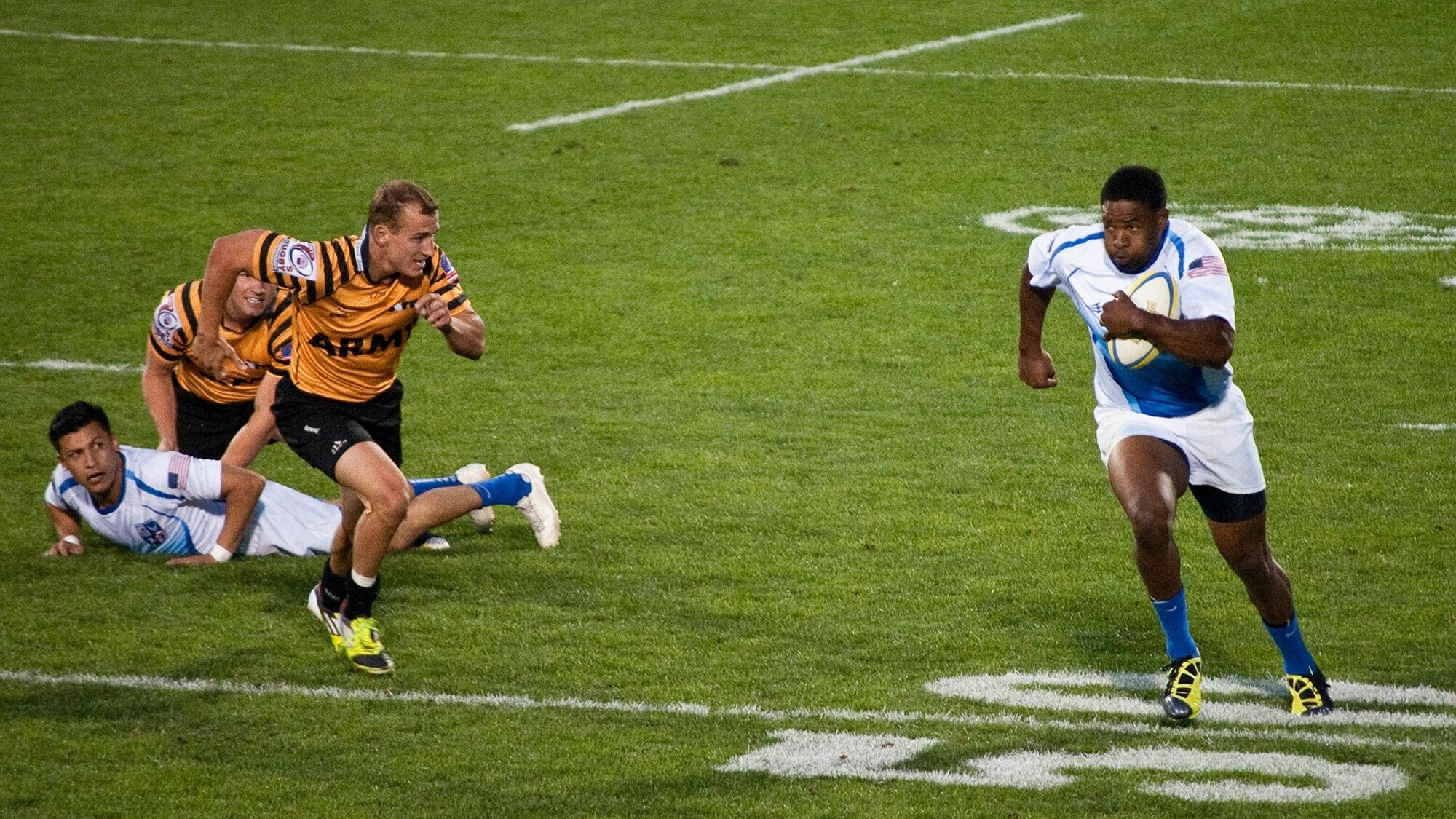 Master Sgt. Cameron Freeman (right) charges up the pitch (the playing field) during a 2013 match put between the Air Force team and the Army. The match was part of the 2013 Armed Forces Rugby tournament where the Air Force ultimately took second place overall. (Courtesy photo)