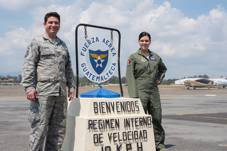 Master Sgt. Alejandro Medina, 571st Mobility Support Advisory Squadron air advisor, takes a picture with his daughter Senior Airman Giannina, sensor operator at Creech AFB, Nevada, during a training mission at La Aurora Air Base, Guatemala. 