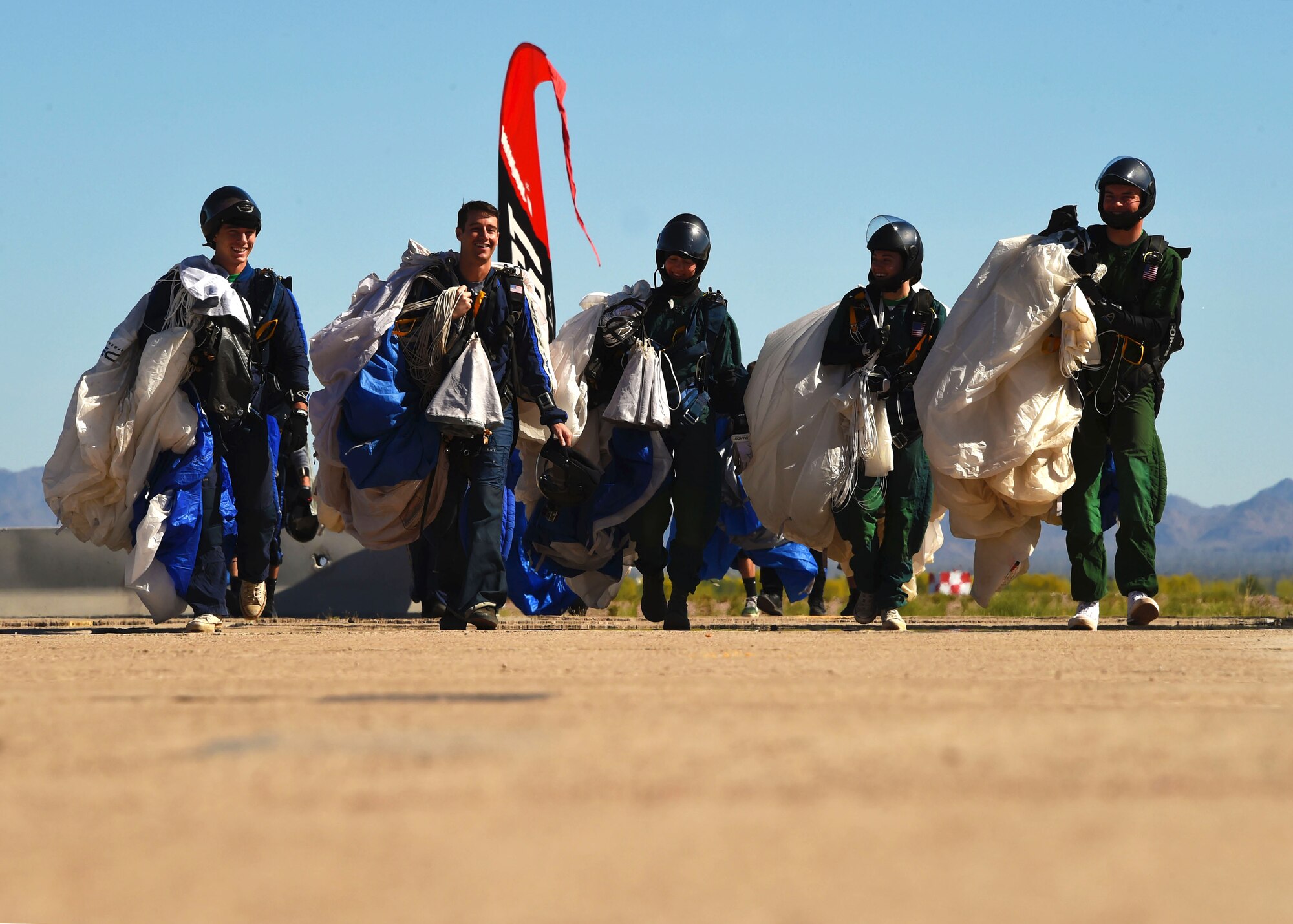 Cadets from the Wings of Blue Parachute team walk back to the hangar after a successful jump from approximately 12,000 feet, March 29, 2017 at the Barry M. Goldwater Range in Gila Bend, Ariz. The Wings of Blue organizes more than 19,000 training jumps annually and more than 2,000 of those will be conducted during the team’s time at Gila Bend. (U.S. Air Force photo by Airman 1st Class Caleb Worpel)