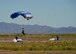 A cadet from the Wings of Blue Parachute Team prepares to land in a designated zone, March 29, 2017 at the Barry M. Goldwater Range in Gila Bend, Ariz. The Wings of Blue performs at Air Force events such as air shows and footballs games as well as select professional sporting events.  (U.S. Air Force photo by Airman 1st Class Caleb Worpel)