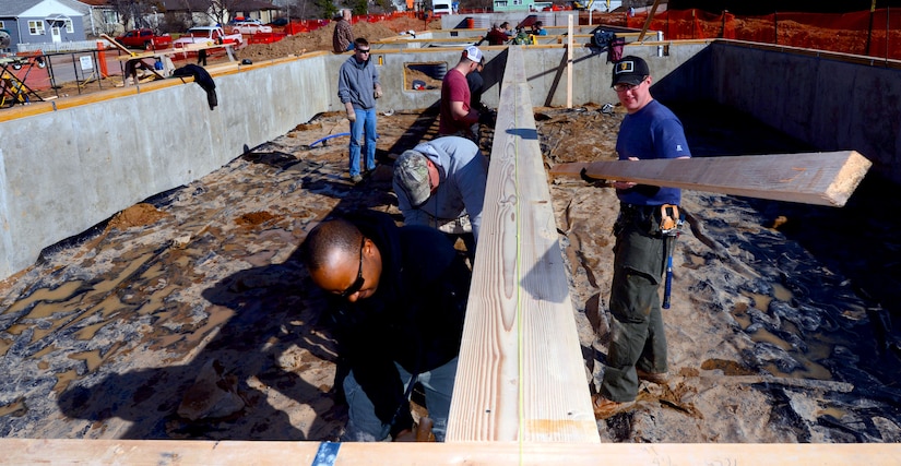 Members of the 28th Civil Engineer Squadron finish installing low-barring walls in a Habitat for Humanity home in Rapid City, S.D., March 23, 2017. During the build, members of the 28th CES were able to participate as a team and enhance their construction skills for use while deployed. (U.S. Air Force photo by Airman 1st Class Donald C. Knechtel)