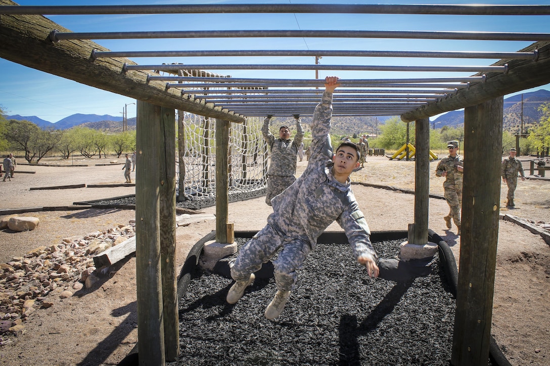 Army Spc. Julian Ditona swings across an obstacle at Fort Huachuca, Ariz., March 28, 2017. Ditona, a multichannel transmission systems operator/maintainer, is a reservist assigned to the 98th Expeditionary Signal Battalion, 335th Signal Command. He and seven other soldiers are competing in the command’s 2017 Best Warrior Competition, hoping to represent their unit at the main event later this year. Army Reserve photo by Sgt. 1st Class Brent C. Powell