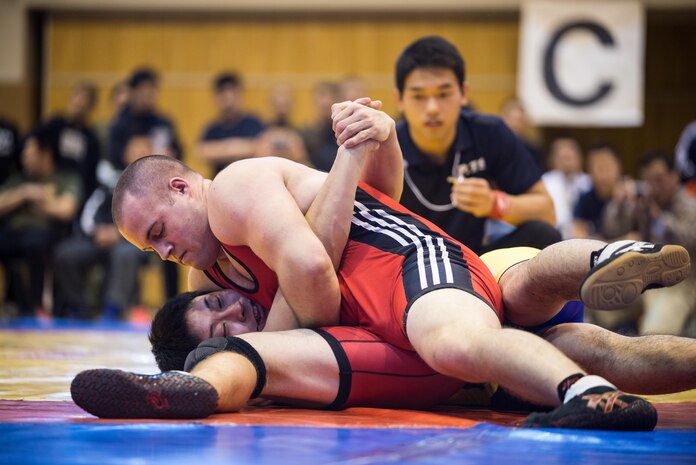 Pfc. Scott Lohndorf, assigned to Headquarters and Headquarters Squadron from Marine Corps Air Station Iwakuni, wrestles his opponent during the 23rd Annual All Japan Self-Defense Force Wrestling Tournament in Camp Asaka, Japan. Lohndorf wrestled with the “Seahawks” Navy Wrestling Team from Fleet Activities Yokosuka. (Courtesy photo by Mass Communication Specialist 1st Class Anthony R. Martinez)