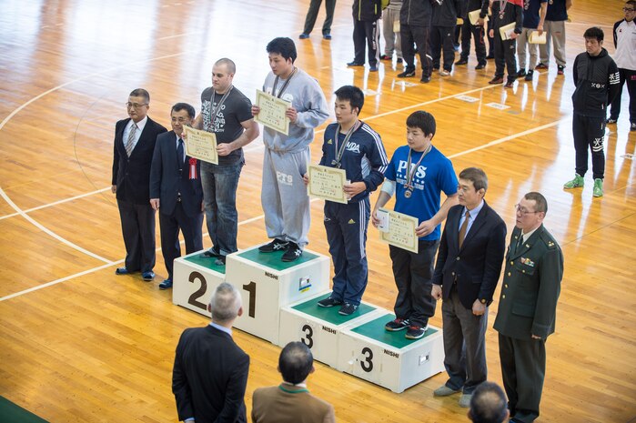 Pfc. Scott Lohndorf, assigned to Headquarters and Headquarters Squadron from Marine Corps Air Station Iwakuni, poses for a photo during the 23rd Annual All Japan Self-Defense Force Wrestling Tournament closing ceremony in Camp Asaka, Japan. Lohndorf wrestled with the “Seahawks” Navy Wrestling Team from Fleet Activities Yokosuka and took 2nd place in the 86kg weight class division. (Courtesy photo by Mass Communication Specialist 1st Class Anthony R. Martinez)