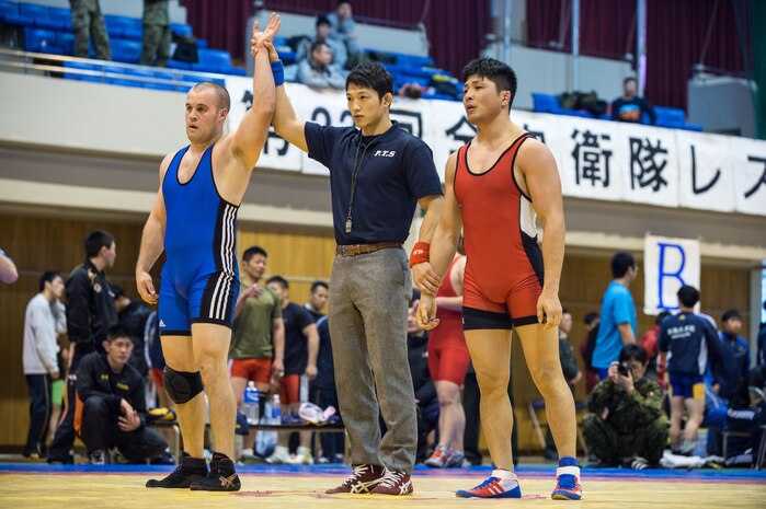 Pfc. Scott Lohndorf, assigned to Headquarters and Headquarters Squadron from Marine Corps Air Station Iwakuni, wins his match during the 23rd Annual All Japan Self-Defense Force Wrestling Tournament in Camp Asaka, Japan. Lohndorf wrestled with the “Seahawks” Navy Wrestling Team from Fleet Activities Yokosuka. (Courtesy photo by Mass Communication Specialist 1st Class Anthony R. Martinez)