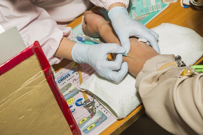 A Japanese volunteer prepares to test a donor’s blood during a blood drive at Marine Corps Air Station Iwakuni, Japan, March 7, 2017. The blood is tested to make sure there are no contagious diseases before the donor can give blood. The volunteers collaborated together and collected approximately 24,000 milliliters of blood from 59 Japanese and American donors. (U.S. Marine Corps photo by Pfc. Stephen Campbell)