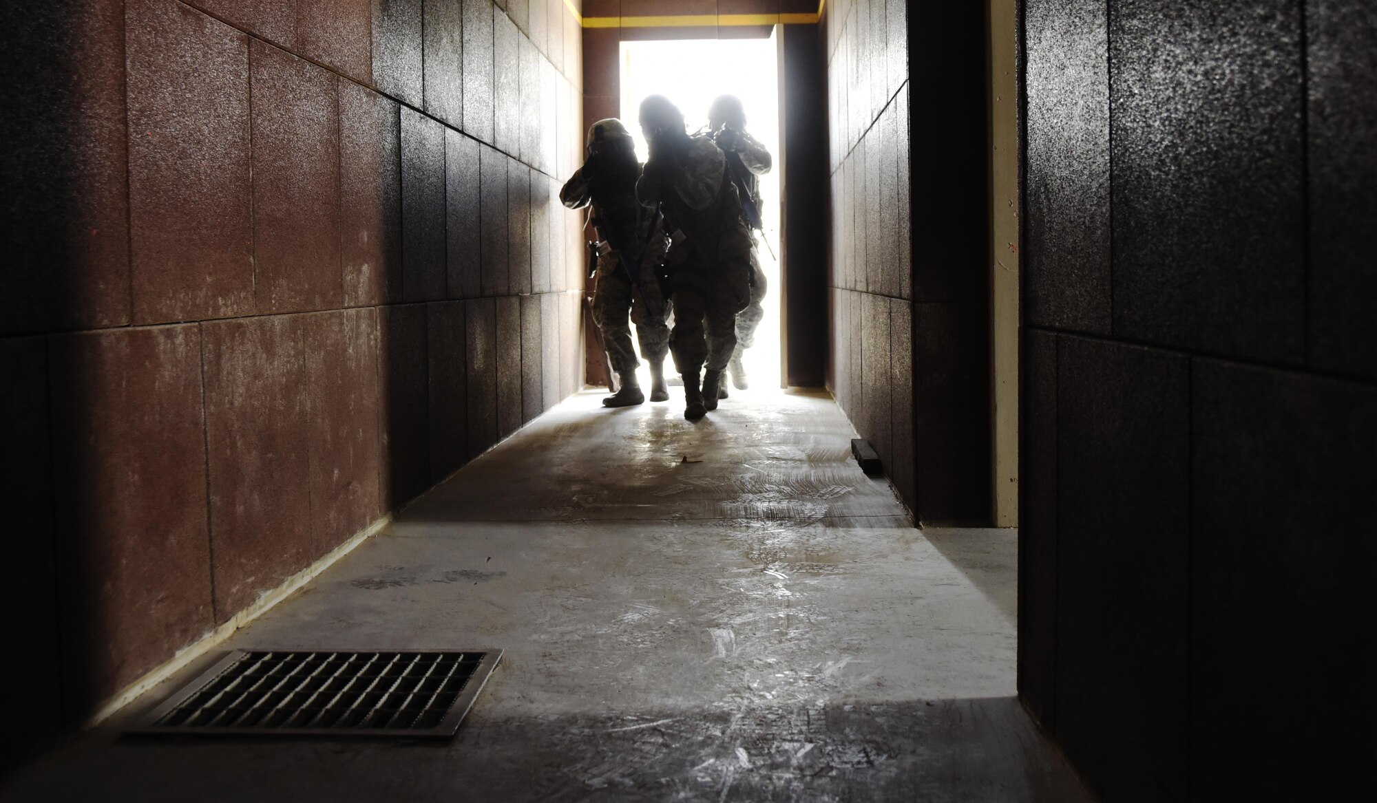 U.S. Air Force patrolmen with the 379th Expeditionary Security Forces Squadron breach the threshold of an active shooter training facility at Al Udeid Air Base, Qatar, March 30, 2017. Active shooter incident response training is conducted often for 379th ESFS Airmen due to the unpredictable nature of active shooters. (U.S. Air Force photo by Senior Airman Cynthia A. Innocenti)