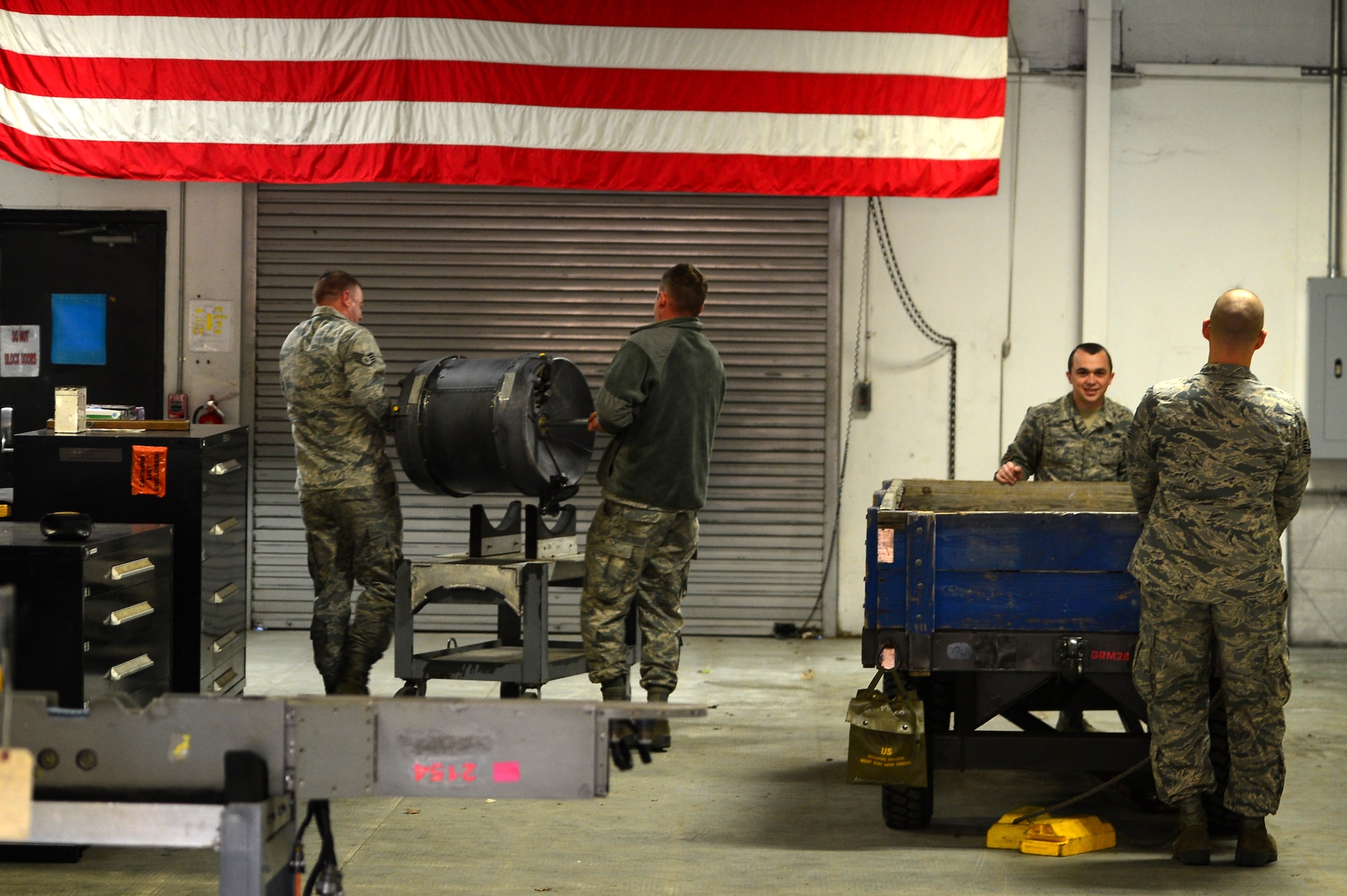 U.S. Airmen assigned to the 20th Equipment Maintenance Squadron aircraft armament flight load parts of an M-61A1 20 mm multi-barrel cannon onto an inspection platform at Shaw Air Force Base, S.C., March 29, 2017. The cannon being inspected is comprised of six barrels and is tested for operations security before being installed onto an F-16CM Fighting Falcon. (U.S. Air Force photo by Airman 1st Class Christopher Maldonado)
