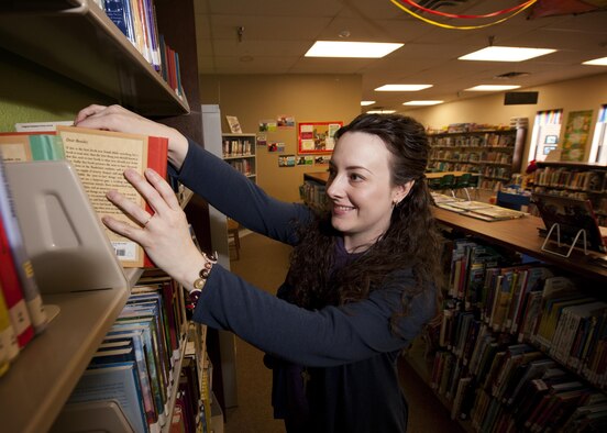 Marsha Adkins, 5th Forces Support Squadron library aide, shelves childrens’ books at Minot Air Force Base, N.D., March 21, 2017. The library is a family-friendly environment featuring a kids section with books, movies, toys and a 3-D printer. (U.S. Air Force photo/Senior Airman J.T. Armstrong)