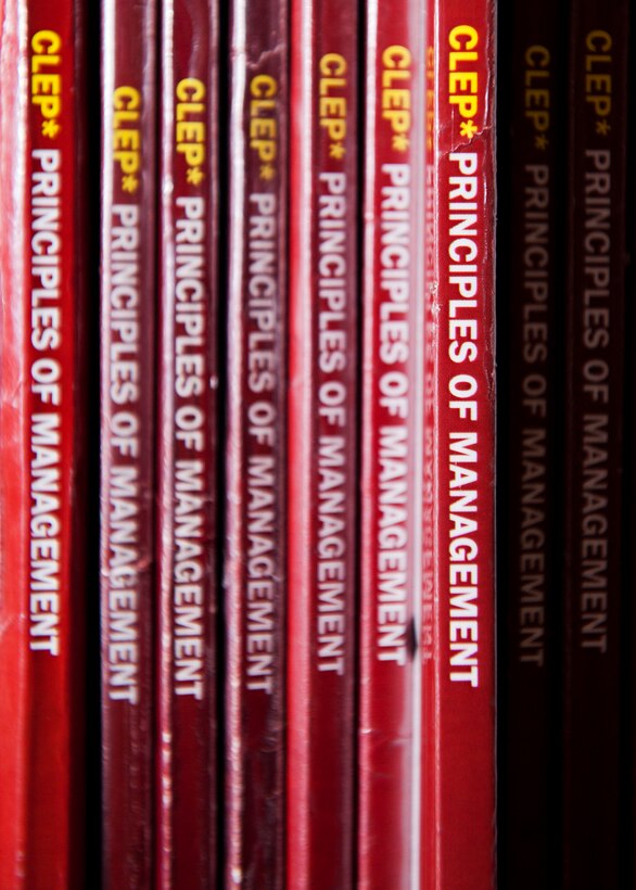 College level examination program study books sit on a shelf at Minot Air Force Base, N.D., March 21, 2017. The MAFB library allows Team Minot members to check out up to 50 books and seven DVDs at a time, and renew their books once online. (U.S. Air Force photo/Senior Airman J.T. Armstrong)