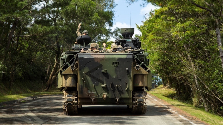 An assault amphibious vehicle maneuvers its way to Combat Town during a mechanized raid exercise March 15 in the Central Training Area, Okinawa, Japan. Waves of AAVs loaded with 31st MEU Marines disembarked the USS Bonhomme Richard and stormed Kushi Crossing Beach. Once on land, the AAVs made their way to Combat Town, a training village in the CTA where Marines train military operations in urban terrain.