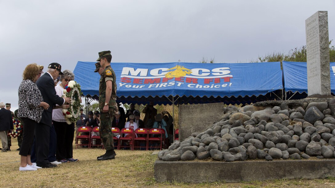 World War II veterans prepare to place a wreath at the base during a wreath-laying presentation as part of the 72nd Reunion of Honor ceremony on Iwo To, Japan March 25, 2017. The event presented the opportunity for the U.S. and Japanese people to mutually remember and honor thousands of service members who fought and died on the hallowed grounds of Iwo Jima. (U.S. Marine Corps photo by MCIPAC Combat Camera Lance Cpl. Brooke Deiters)