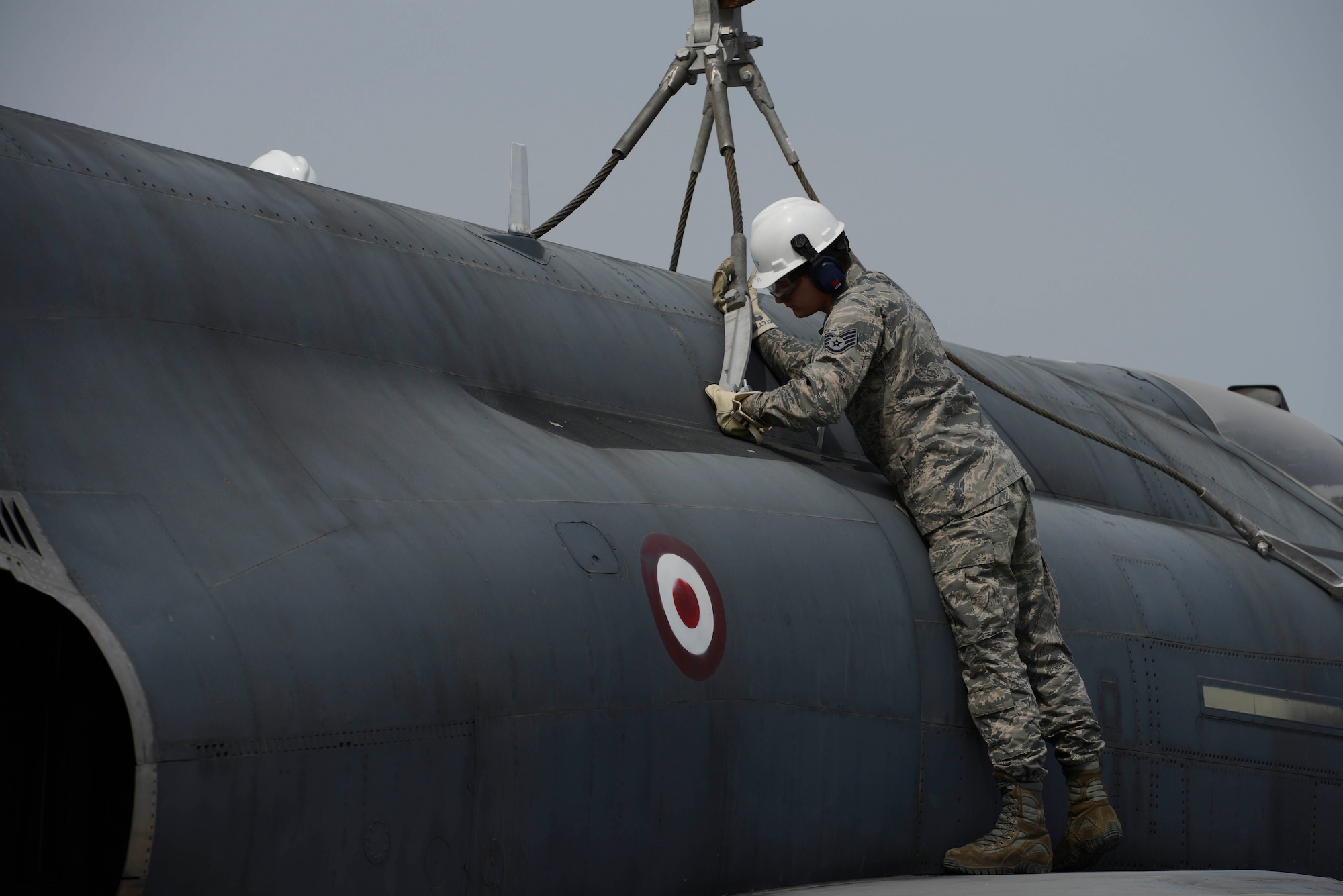 U.S. Air Force Staff Sgt. Corey Nickles, 39th Maintenance Squadron transient alert, Crash Damaged Disabled Aircraft Recovery (CDDAR) team member, attaches a crane to a decommissioned Turkish air force F-4 Phantom as part of a training exercise March 30, 2017, at Incirlik Air Base, Turkey. The primary objective of the CDDAR mission is to quickly and safely remove immobile aircraft and return the runway to operational status. (U.S. Air Force photo by Airman 1st Class Devin M. Rumbaugh)