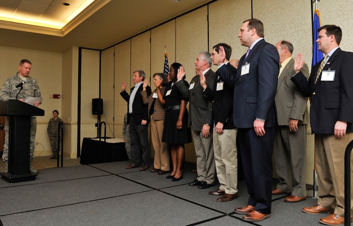 Col. Robert Lyman, Joint Base Charleston commander, administers the honorary commander oath of office to newly inducted honorary commanders, March 24, 2017 at Joint Base Charleston, South Carolina. The purpose of the honorary commanders program is to increase public awareness and understanding of the base's mission, policies and programs. The program's goal is to foster goodwill, understanding and support from the Charleston community through personal relationships built with community leaders.