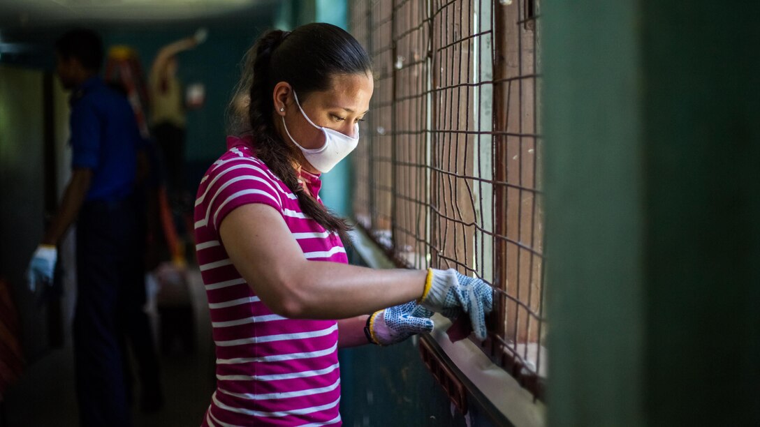 1st Lt. Haley Mansberger, the adjutant with Combat Logistics Battalion 11, 11th Marine Expeditionary Unit, sands a window fixture prior to painting it during a community relations project held at the Ratmalana School for the Deaf and Blind, as part of a theater security cooperation engagement in Colombo, March 28. Both the U.S. and Sri Lanka have a continuing interest in strengthening their partnership based on common interests related to maritime security, humanitarian assistance and disaster relief preparedness, and security and stability in the region.